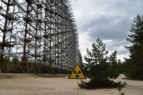 A radioactive warning sign in front of the Duga Radar Station in the Cherno.. Фото