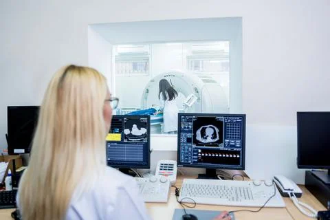 Radiologist in the control room of computed tomography at hospital Stock Photos