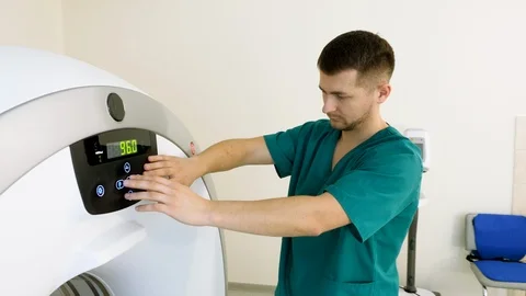 Radiologist controls CT or MRI or PET scan with elderly female patient. 4K Stock Footage 122664125