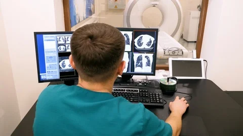 Radiologist looking at monitors with lungs activity results in control room. 4K Stock Footage 123211024