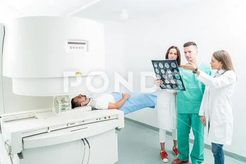 Radiology, surgery, people and medicine concept - female doctors looking to a Stock Photos