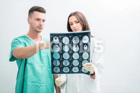 Radiology, surgery, people and medicine concept - female doctors looking to a Stock Photos
