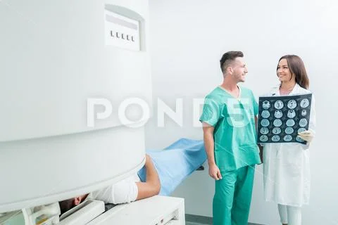 Radiology, surgery, people and medicine concept - female doctors looking to a Stock Photos
