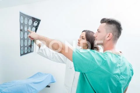 Radiology, surgery, people and medicine concept - female doctors looking to a Stock Photos