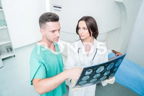 Radiology, surgery, people and medicine concept - female doctors looking to a Stock Photos