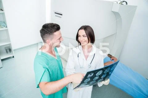 Radiology, surgery, people and medicine concept - female doctors looking to a Stock Photos