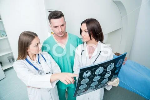 Radiology, surgery, people and medicine concept - female doctors looking to a Stock Photos