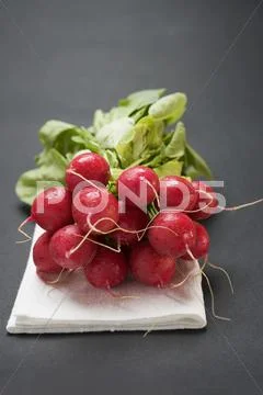 Radishes on linen cloth Stock Photos