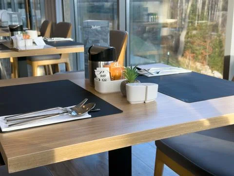 Radisson table setting with cutlery on black placemats inside a restaurant, Stock Photos