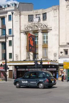 Raditional  black cab in front of the Dominion Theatre in London Stock Photos