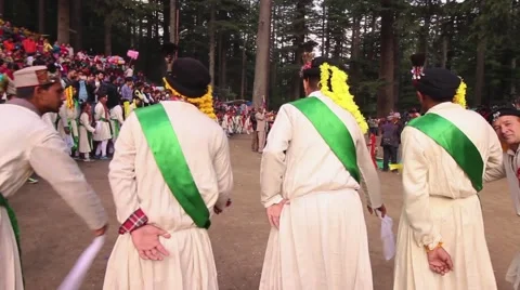 Raditional male dancers wave flags and move in line, rear still shot. Stock Footage 66548394