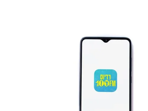 Radius 100FM app launch screen with logo on the display of a black mobile sma Stock Photos