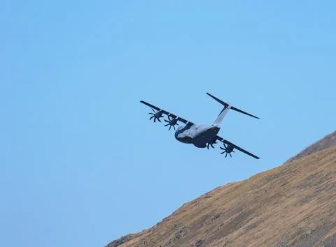 An RAF transporter plane flying over Grasmere, Lake District, UK. Stock Photos