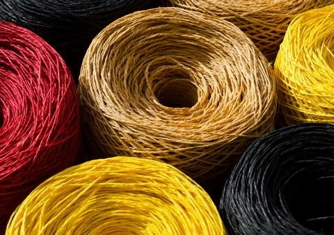 Raffia balls close-up. Skeins of multi-colored raffia are ready for knitting. Stock Photos