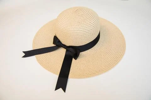 Raffia Straw summer hat with black ribbon on a white background. Stock-Fotos
