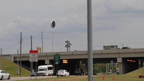 Raffic on a bridge and underpass with restaurant signs urban scenery Stock Footage 153571077