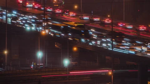 Raffic flow on the elevated road and vehicles in the city at night Stock Footage 296065522