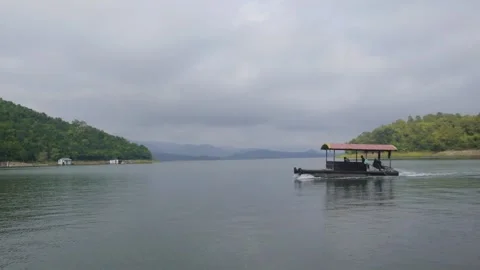 The raft is driven from right to left on the water surface of the dam Stock Footage 255259473