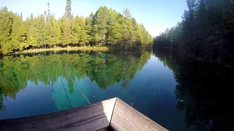 Raft slowly moves out into large cold spring Video stock 81761382