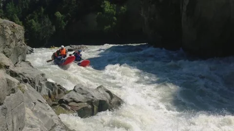 The rafting team descends the rough rapids in the mountain river with paddles. Stock-Footage 237026274