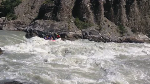 The rafting team descends the rough rapids in the mountain river with paddles. Stock-Footage 237026295