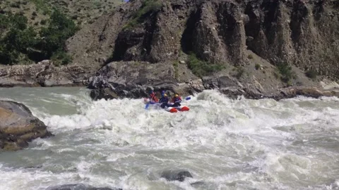 The rafting team descends the rough rapids in the mountain river with paddles. Stock Footage 237026315
