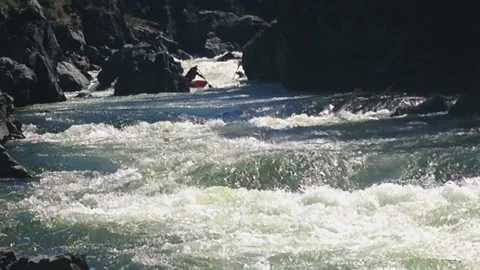 The rafting team descends the rough rapids in the mountain river with paddles. Stock-Footage 237026325
