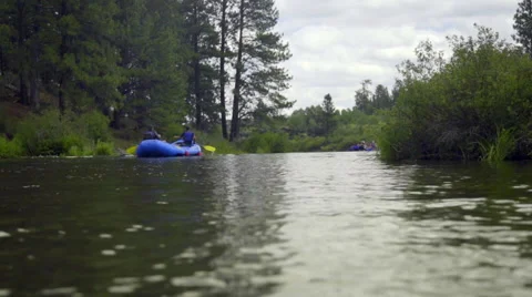 Rafts float smoothly down a river Stock Footage 59736317