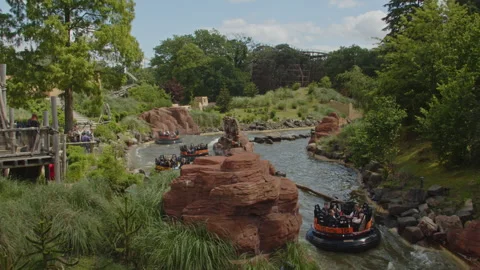 Rafts going through a rapid river ride in the Efteling amusement park in the Stock Footage 337894914