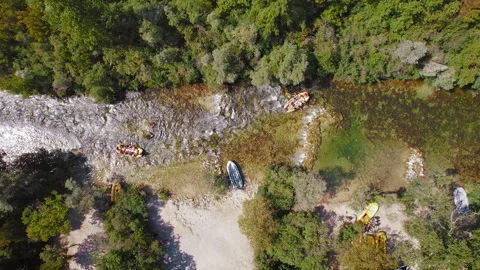 Rafts with groups of people navigate the clear waters of the Cetina river Stock Footage 279936148