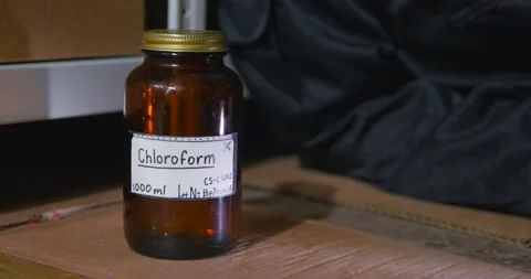 A rag falls on the surface next to a jar of chloroform, close up. Improper use Stock Footage 165370924