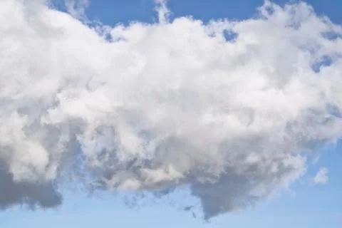 Ragged Cumulus cloud in blue sky Stock Photos