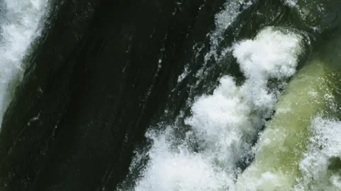Raging dark river water creating whitewater rapids Stock Footage 333147514