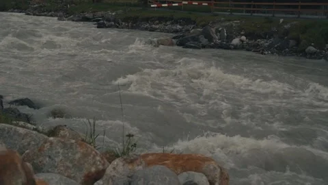 Raging fast narrow mountain river in Switzerland slow motion Stock Footage 318598854