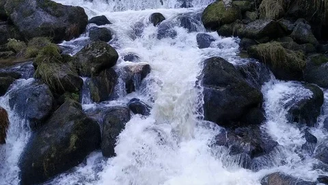 A raging mountain stream rumbles in the mountains Stock Footage 126688651