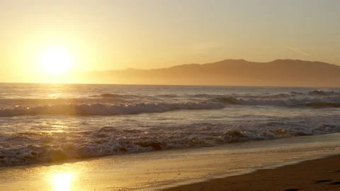 Raging ocean with golden sunset background in Los Angeles Stock Footage 197816223