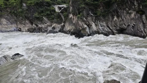 Raging River in Tiger Leaping Gorge with Arch Bridge and Stone Tiger Stock Footage 340130736