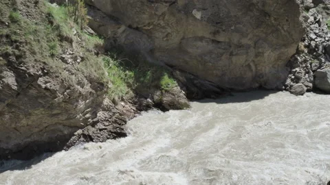 Raging river in wild mountain with boiling water stream. Stormy mountain river Stock Footage 130891615