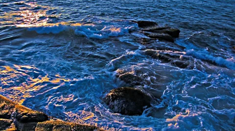 Raging sea in the rocks at sunset Video stock 33309603