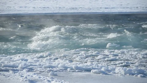 Raging soaring stream of a mountain river in the winter frosty season Stock Footage 168744010