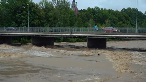 Raging water flows under the bridge Stock Footage 247442282