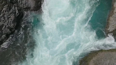 Raging Waterfall Over Dark Rocks in Narrow Gorge Stock Footage 310612791