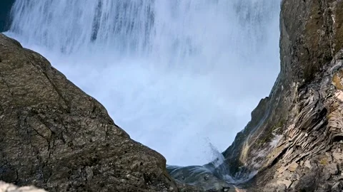 Raging waterfall surrounded by rocks. Includes the sound of the falling water. Stock Footage 173552981