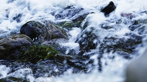 Raging waterfall water flows over rock piles Stock Footage 235900915