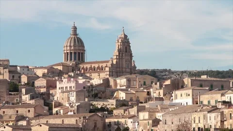 Ragusa sicily italy town medium shot church buildings homes houses on hill Stock Footage 252155774