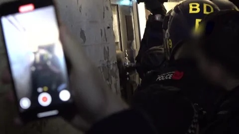 Raid takes place in Prescot as eight arrested on suspicion in multimillion-poun Stock Footage 322594896