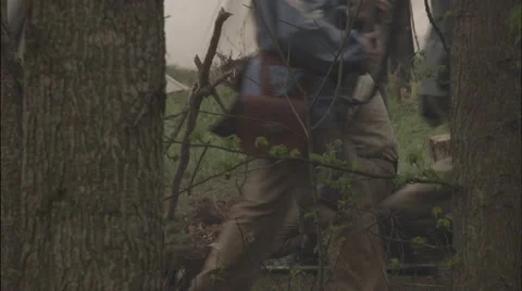 Raiders pass through camp as one eats at campfire, Civil War scenes Stock Footage 39986493