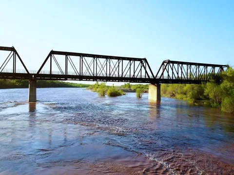 Rail Bridge over a flowing river Stock Footage
