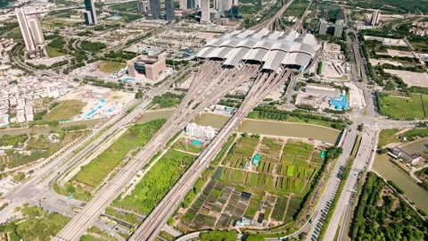 Rail corridor and green plots at Guangzhou South station Stock Footage 346630833