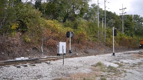 Rail freight train moving down the railroad track carrying wagons with cargo Stock Footage 85675697
